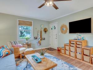 a living room with a flat screen tv on the wall at Salt Palms Cottage in Tybee Island