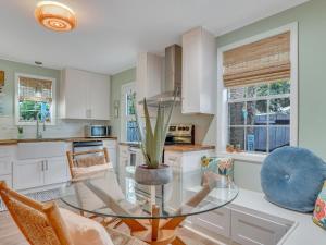 a kitchen with a glass table with a potted plant at Salt Palms Cottage in Tybee Island