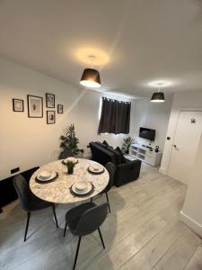 a living room with a table and a couch at 2 bedroom flat in London