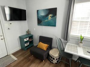 a living room with a desk and a chair at The Lafayette 'Tiny Home' Apartment in Lafayette