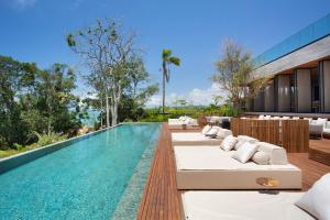 an outdoor swimming pool with lounge chairs and a resort at Fuso Concept Hotel in Florianópolis