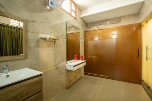 a bathroom with a sink and a shower at Zamin Resort in Kuttālam