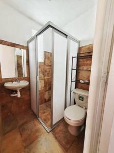 a bathroom with a toilet and a sink at Casa Juárez 2 in Oaxaca City