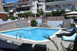 a swimming pool in front of a building at Christina Studios & Apartments in Parga