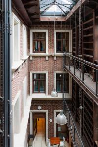 an internal view of a brick building with a glass ceiling at Palazzo Rosso Old Town in Poznań