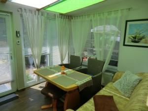 a living room with a table and a couch at Ferienhaus Zingst MinHus in Zingst