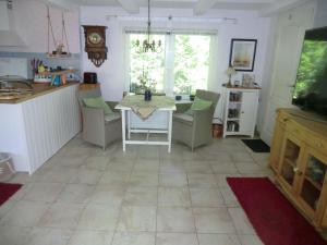 a kitchen with a table and chairs in a room at Ferienhaus Zingst MinHus in Zingst