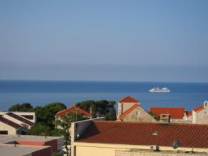 a cruise ship in the ocean behind a city at Guest House Maria Bilicic in Dubrovnik