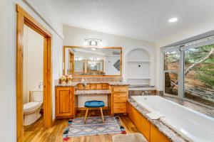 a bathroom with a tub and a sink and a toilet at Lazy K on Peaceful Bay - Ranch House in Lakeside +23 photos