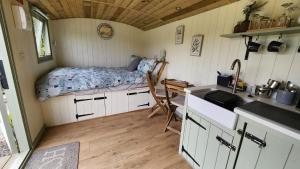 a small bedroom with a bed in a tiny house at Shepherds Delight in Launceston