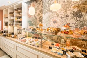 a bakery with a display case filled with lots of food at Hotel Germania in Cochem
