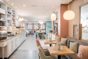 a restaurant with tables and chairs and a counter at Hotel Germania in Cochem