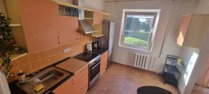 a small kitchen with a sink and a stove at Eva's apartments in Kaunas