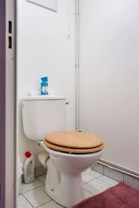 ein Badezimmer mit einem WC und einem hölzernen WC-Sitz in der Unterkunft Canalisez-vous au Bord du Canal in Aubervilliers