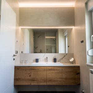 a bathroom with a sink and a large mirror at The Park Apartment in Zadar