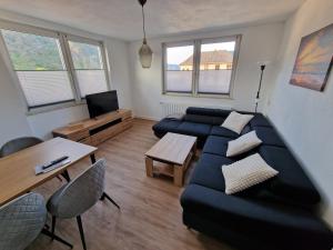 a living room with a couch and a table at Ferienwohnungen Lenz in Cochem