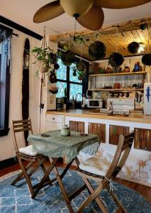 a kitchen with a table and two chairs in a room at Cozy AF Jungle-House Hideaway in Tampa