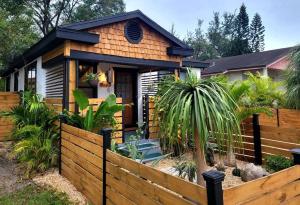 a house with a wooden fence in front of it at Cozy AF Jungle-House Hideaway in Tampa