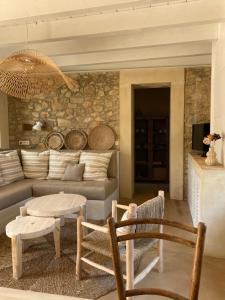 a living room with a couch and a table and chairs at Mas Ferran Adults Only in Pals