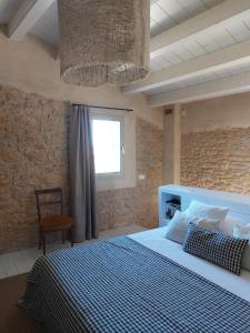 a bedroom with a large bed and a window at Mas Ferran Adults Only in Pals