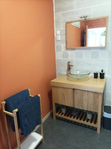 a bathroom with a sink and a mirror at Le Mc Fly in Hénin-Beaumont