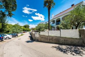 a building with a fence in front of a street at The Park Apartment in Zadar