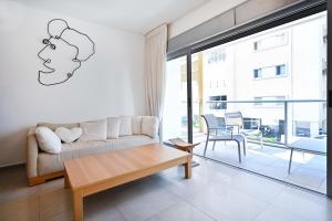 a living room with a couch and a table at Tiramisu for two by HolyGuest in Tel Aviv