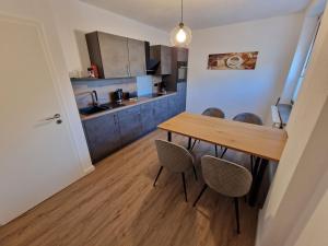 a kitchen with a wooden table and chairs at Ferienwohnungen Lenz in Cochem +6 photos