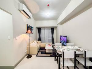 ein Wohnzimmer mit einem Tisch und einem Sofa in der Unterkunft A2J BGC Luxury Uptown 2BR Balcony Suite Near Malls in Manila