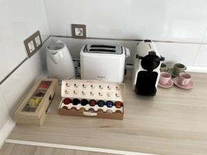 a shelf with a box of wine bottles and a coffee maker at Cozy 2 bedroom apartment with patio in Madrid