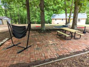 a hammock and a picnic table in a park at Serenity in the Suburbs: Your Gorgeous RVA Getaway in Richmond