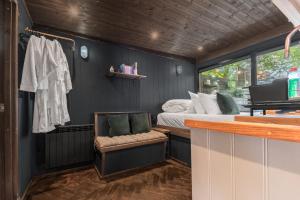 a small room with a bed and a bed and a bar at Wonderland Retreats in Carnforth