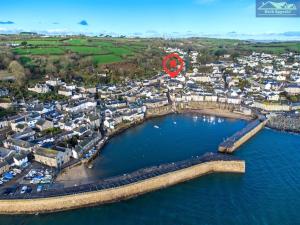 an aerial view of a city with a red circle at Boatsman's Cottage- sleeps 4- Garage- Mousehole in Mousehole