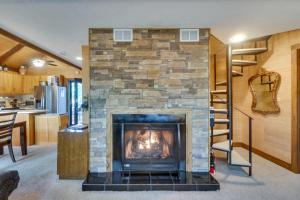 a living room with a fireplace and a kitchen at Wintergreen Home with Hot Tub, Deck and Mountain Views in Wintergreen
