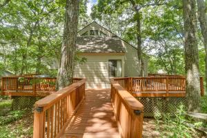 a wooden bridge leading to a house with trees at Wintergreen Home with Hot Tub, Deck and Mountain Views in Wintergreen