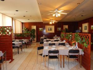 a restaurant with tables and chairs and a ceiling at ABC Hotel Nitra in Nitra