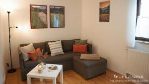 a living room with a couch and a table at Montana - Ferienwohnung am Laber in Oberammergau