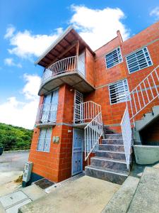 a red brick building with a staircase in front of it at Hostal Casa Doña Eva -Rionegro Antioquia in Rionegro