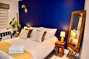 una camera con un grande letto con una parete blu di Stylish centrally-located studio with parking a Croydon