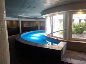 a large swimming pool in a building at LINDABAYPLAYA STUDIO in Mar de las Pampas