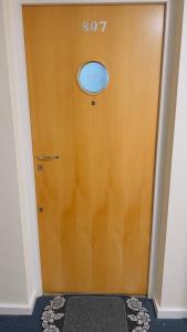 a wooden door with a round window on it at Charming 1-Bedroom Apartment in Woolwich in Woolwich