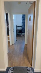 a hallway with a room with a door and a table at Charming 1-Bedroom Apartment in Woolwich in Woolwich