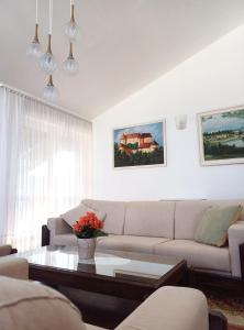 a living room with a couch and a coffee table at Apartma AJDA in Velenje
