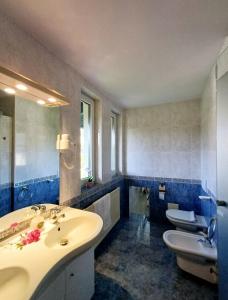 a bathroom with two sinks and a toilet in it at Apartma AJDA in Velenje