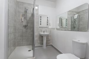 a bathroom with a shower and a toilet and a sink at Plough Hotel in Northampton +47 photos