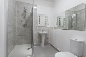 a bathroom with a shower and a toilet and a sink at Plough Hotel in Northampton