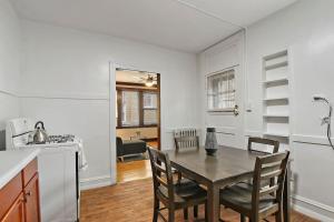a kitchen and dining room with a table and chairs at Warm & Inviting 2BR Apartment - Fullerton 1B in Chicago