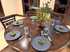 a wooden table with plates of food on it at Pavones Beach Resort in Pavones