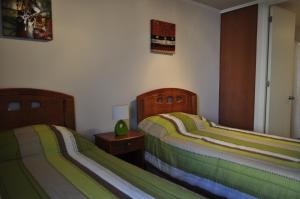 سرير أو أسرّة في غرفة في أجوستيناس بلازا للشقق الفندقية