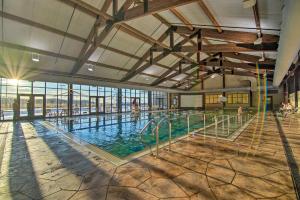 a large indoor swimming pool with people in it at Galena Townhome with Community Perks! in Galena